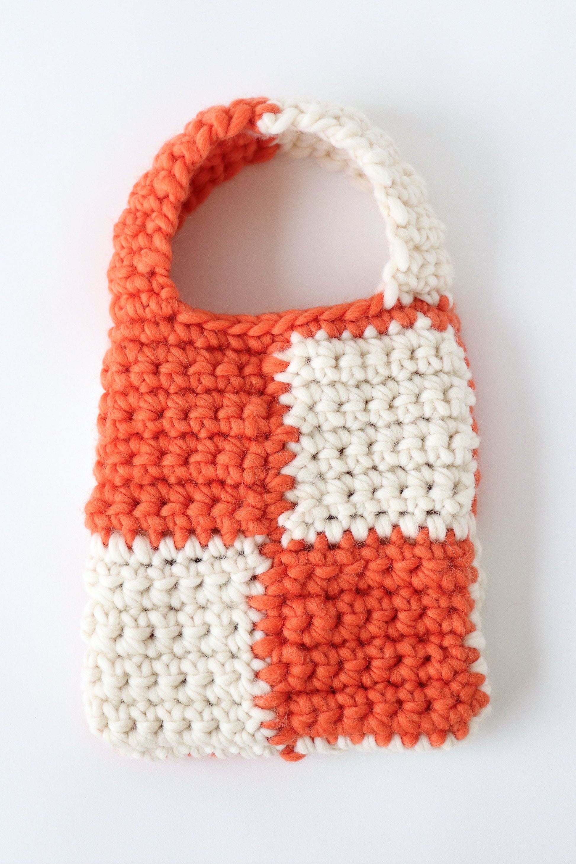 Orange and cream checkered crochet bag handmade with wool yarn.