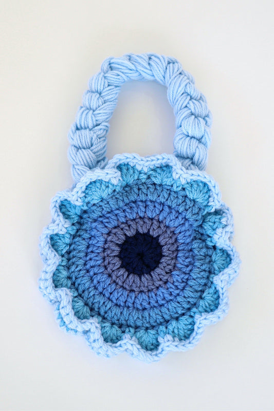 Flower shaped blue ombré crochet shoulder bag handmade with acrylic yarn.