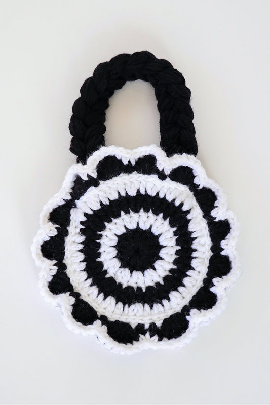 Flower shaped black and white crochet shoulder bag handmade with acrylic yarn.
