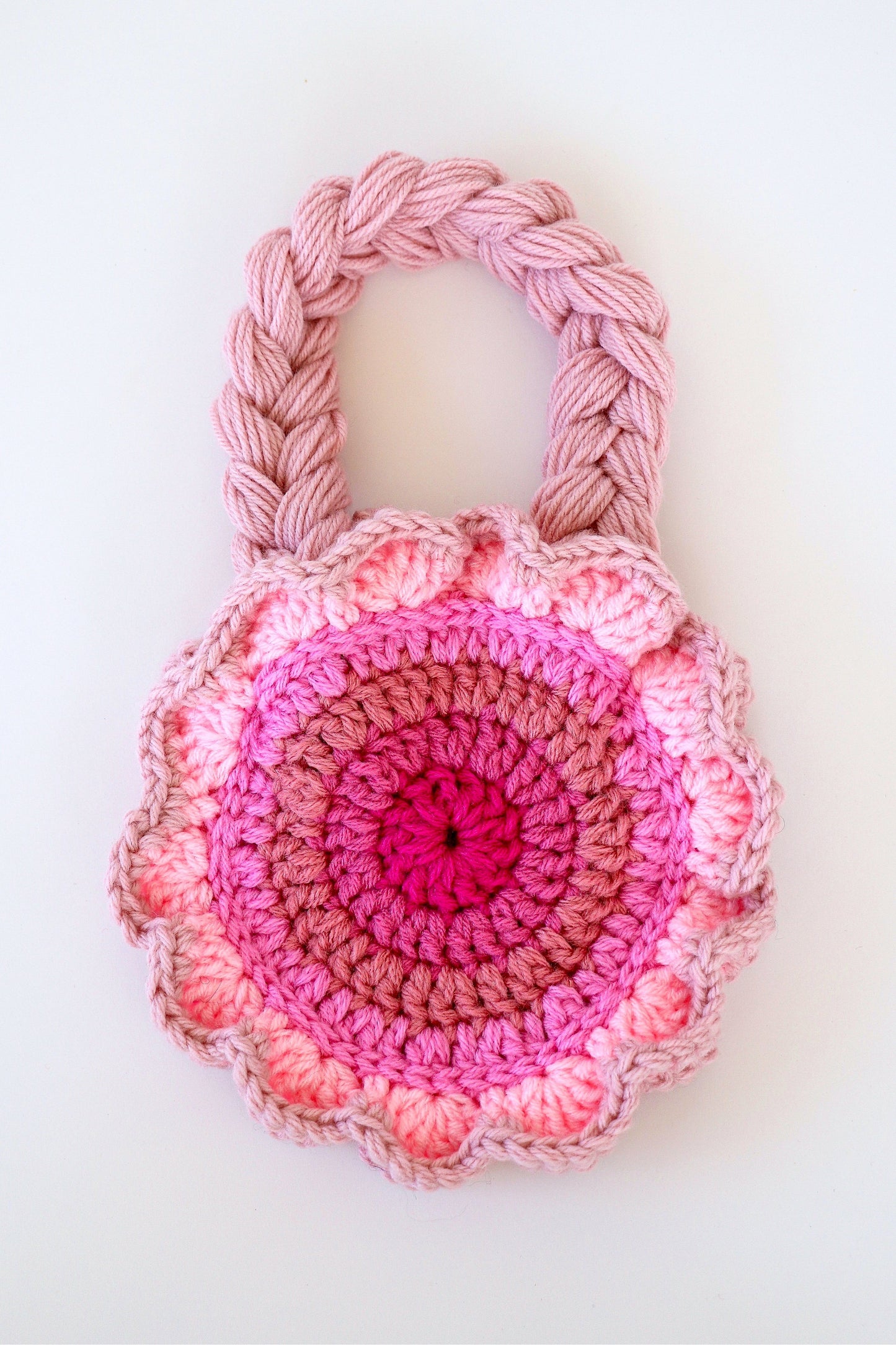 Flower shaped pink ombré crochet shoulder bag handmade with acrylic yarn.