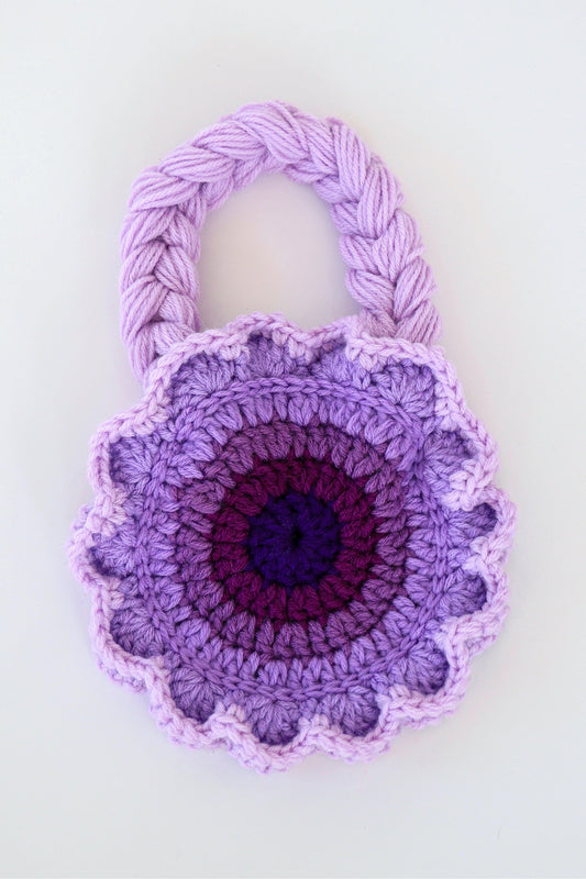 Flower shaped purple ombré crochet shoulder bag handmade with acrylic yarn.