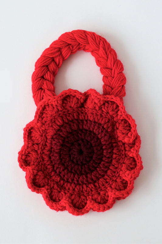Flower shaped red ombré crochet shoulder bag handmade with acrylic yarn.