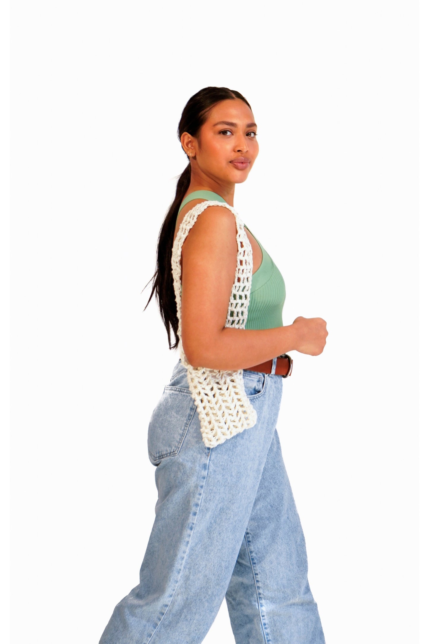 Model wearing a cream crochet fishnet pouch on her arm.