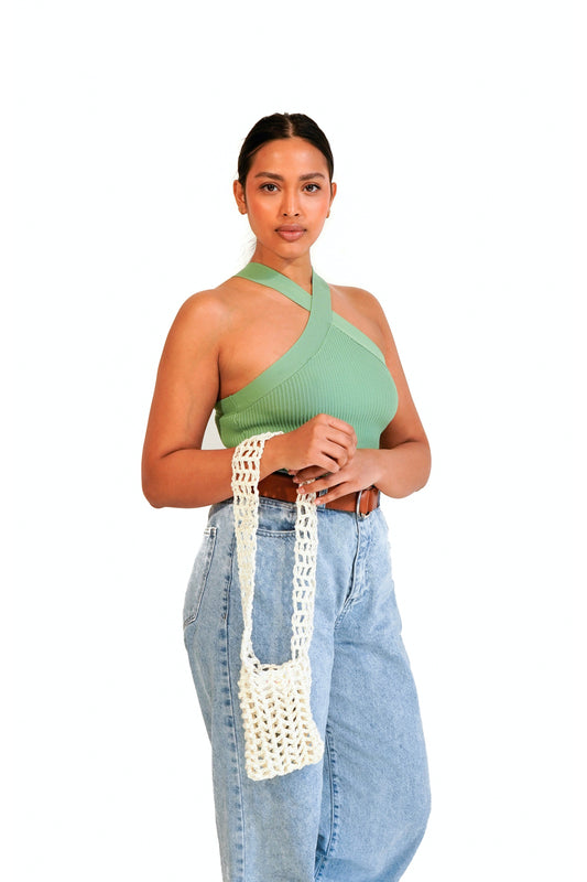 Model wearing cream crochet fishnet pouch on her arm.