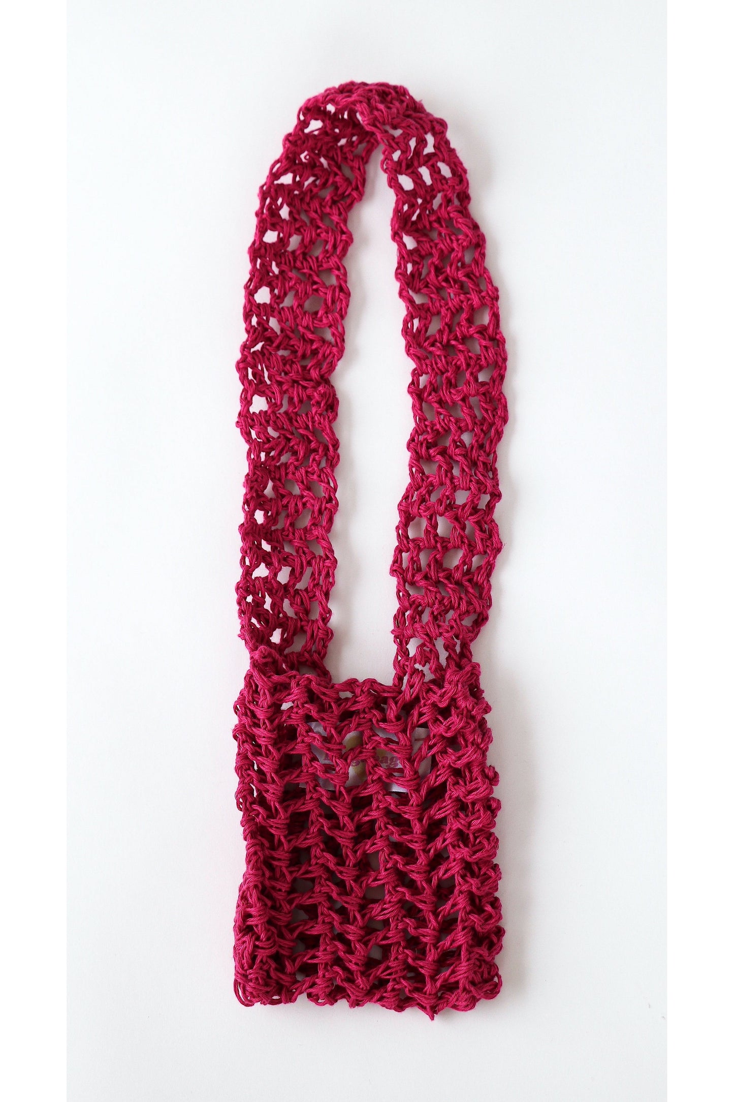 Crochet fishnet style crossbody pouch in fuchsia handmade with linen yarn.