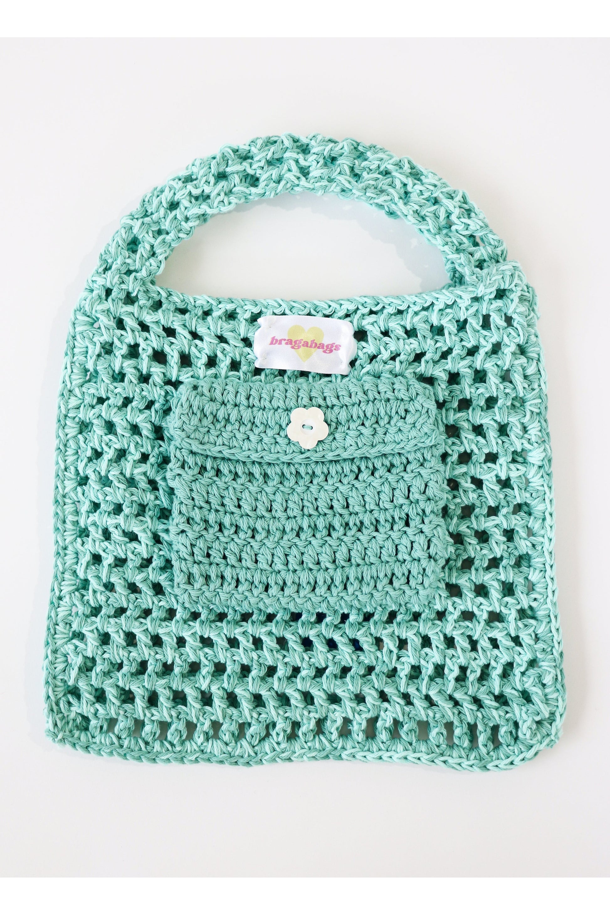 Inside of Caribe color way two-tone crochet fishnet tote bag handmade with cotton yarn.