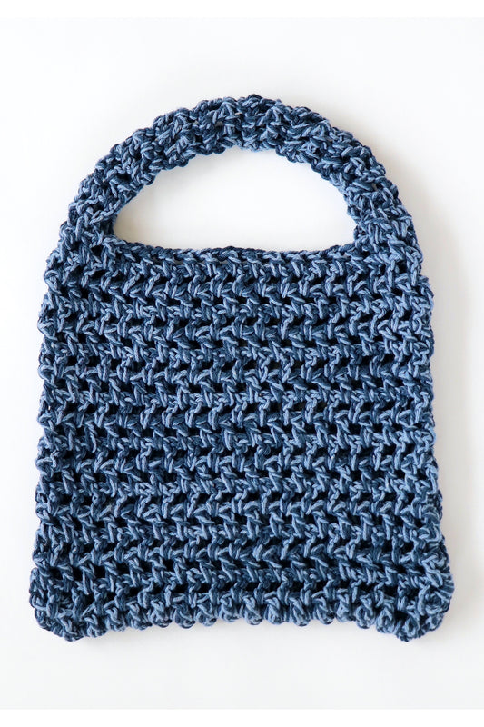 Front of Denim color way two-tone crochet fishnet tote bag handmade with cotton yarn.