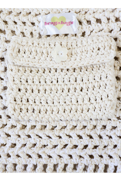 Close up of Milk color way inside crochet pocket with flower button.