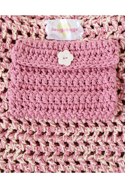 Close up of Shortcake color way inside crochet pocket with flower button.